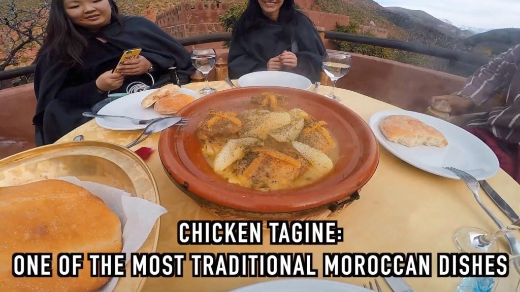 Moroccan chicken tagine is slow cooked in a ceramic pot with dried fruit and served with bread