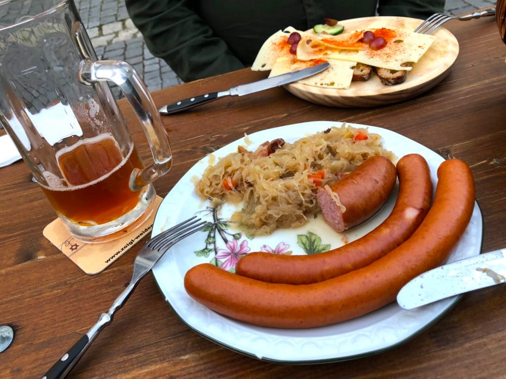 Three wurst sausage plate, bacon sauerkraut, bread and cheese at Kloine Zoigl Stub’n Zum Stich’n